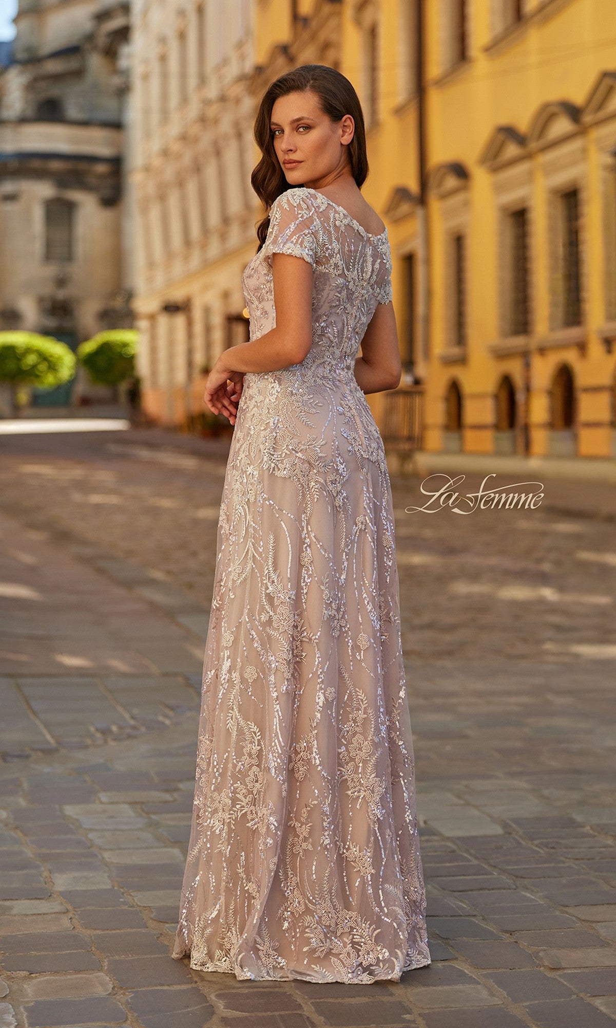 A woman wearing the La Femme 31838 long formal dress, featuring an elegant a-line silhouette and delicate beaded embroidery.